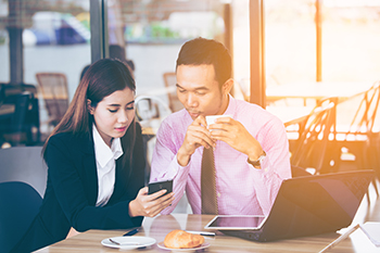 Coworkers sharing cellphone