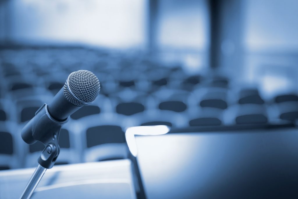 Rostrum with microphone and computer in conference hall