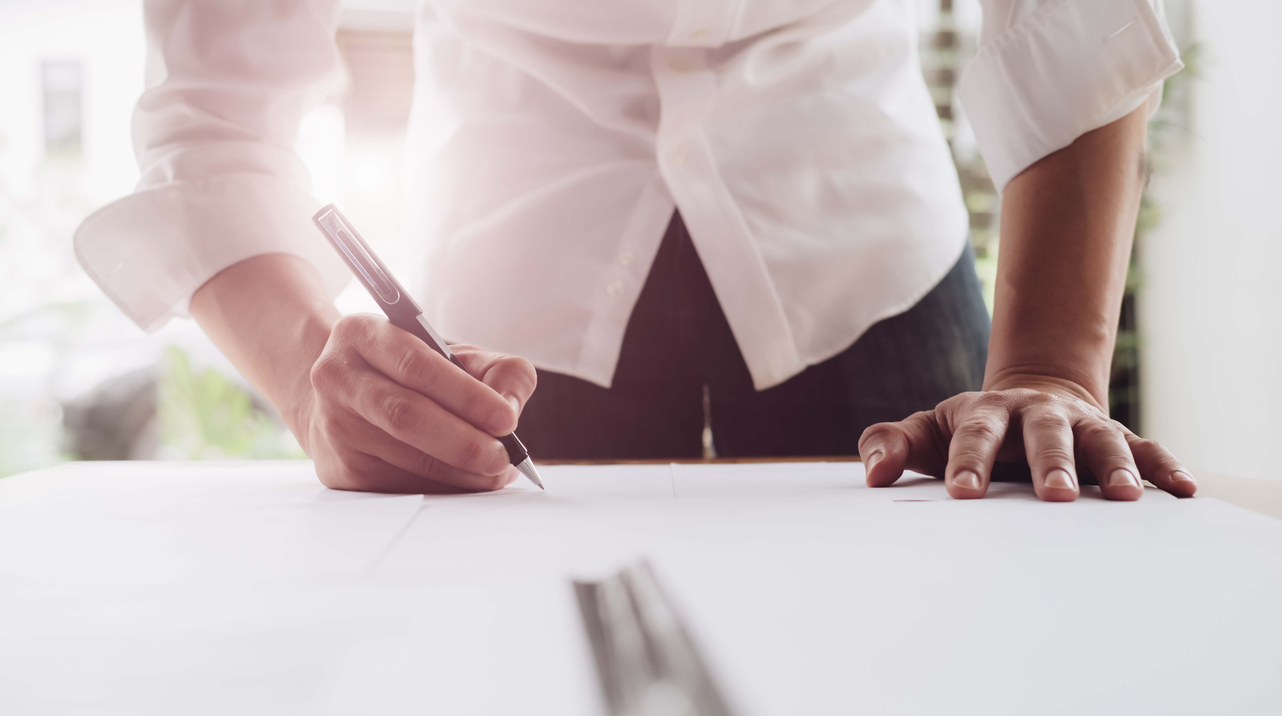 Close up business man reaching out sheet with contract agreement