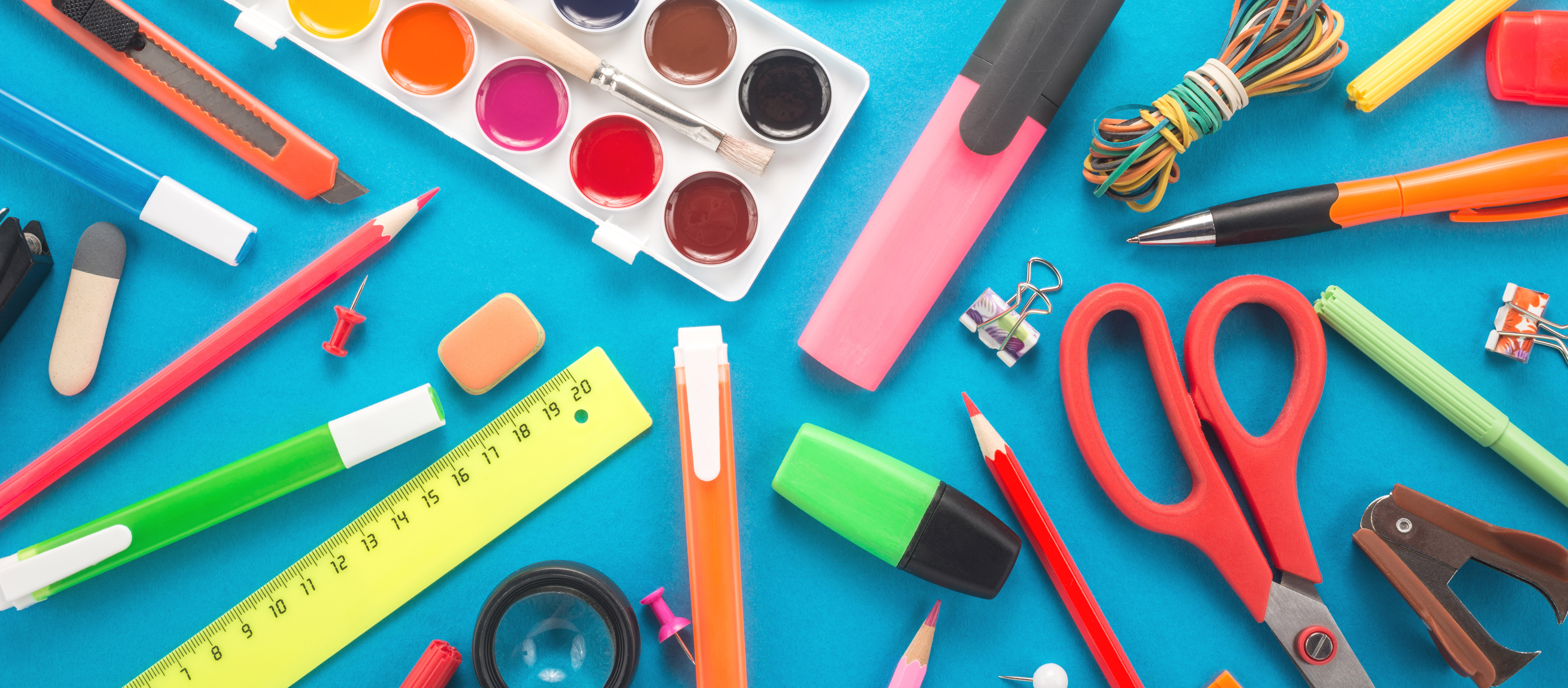 School office supplies on blue background