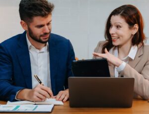 Man and woman talking at laptop