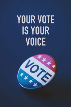 closeup of a vote badge for the United States election on a blue background and the text your vote is your voice